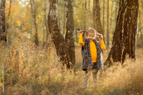 little girl in autumn forest