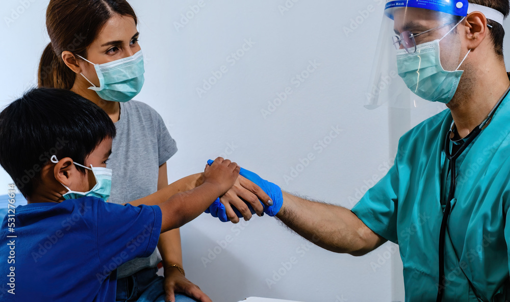 Mother and child check hand with doctor promising to respect doctor's treatment. Health care concept. Mother and child check hand with doctor promising to respect doctor's treatment. Health care concept.