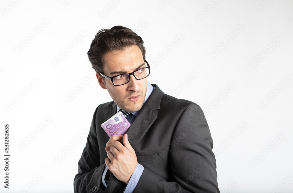 Close-up photo of cunning businessman hiding pack of cash money in his jacket isolated on white background Close-up photo of cunning businessman hiding pack of cash money in his jacket isolated on white background