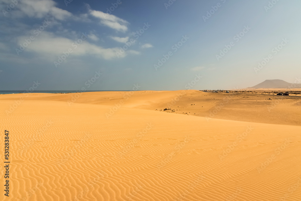 fuerteventura beach with its famous desert sand dunes, corralejo, mount tindaya in the background, estino volcano