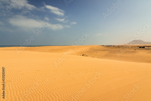 fuerteventura beach with its famous desert sand dunes  corralejo  mount tindaya in the background  estino volcano