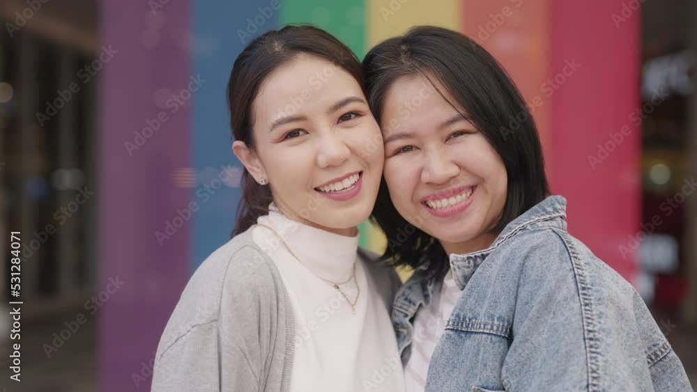 Young adult queer lover transgender asia two gay people fun happy enjoy relax look at camera. LGBT LGBTQIA beauty colorful flag color bisexual family festival hug love smile at city street town. Young adult queer lover transgender asia two gay people fun happy enjoy relax look at camera. LGBT LGBTQIA beauty colorful flag color bisexual family festival hug love smile at city street town.