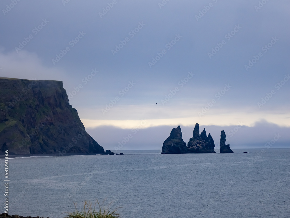 The iconic black sand beaches of Reynisfjara and the sea stacks ...