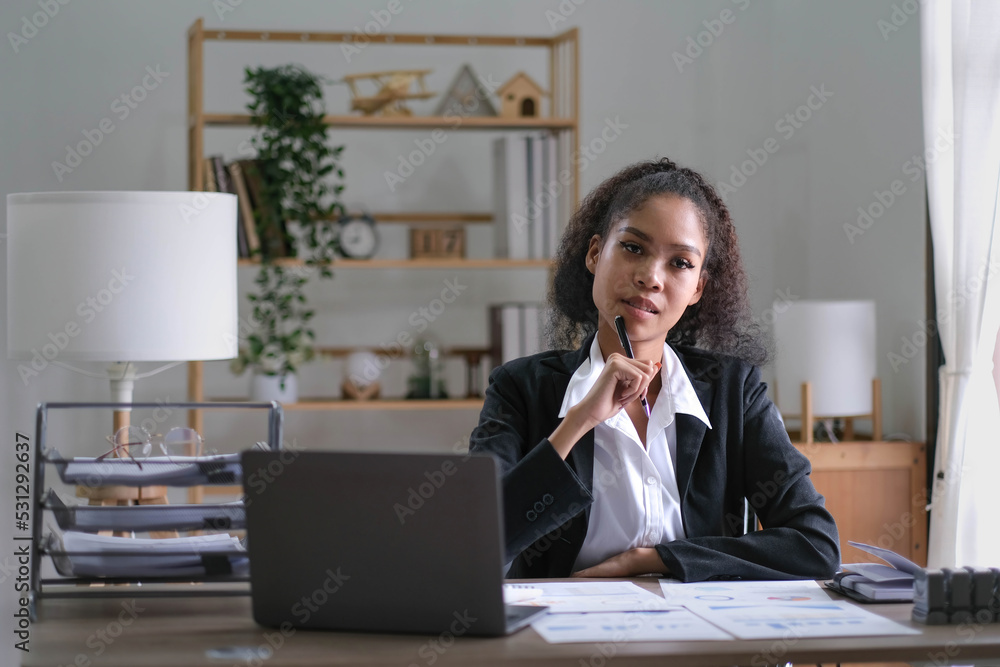 Creative young african american woman working on laptop in her studio,Doing accounting analysis report real estate investment data, Financial and tax systems concept. Creative young african american woman working on laptop in her studio,Doing accounting analysis report real estate investment data, Financial and tax systems concept.