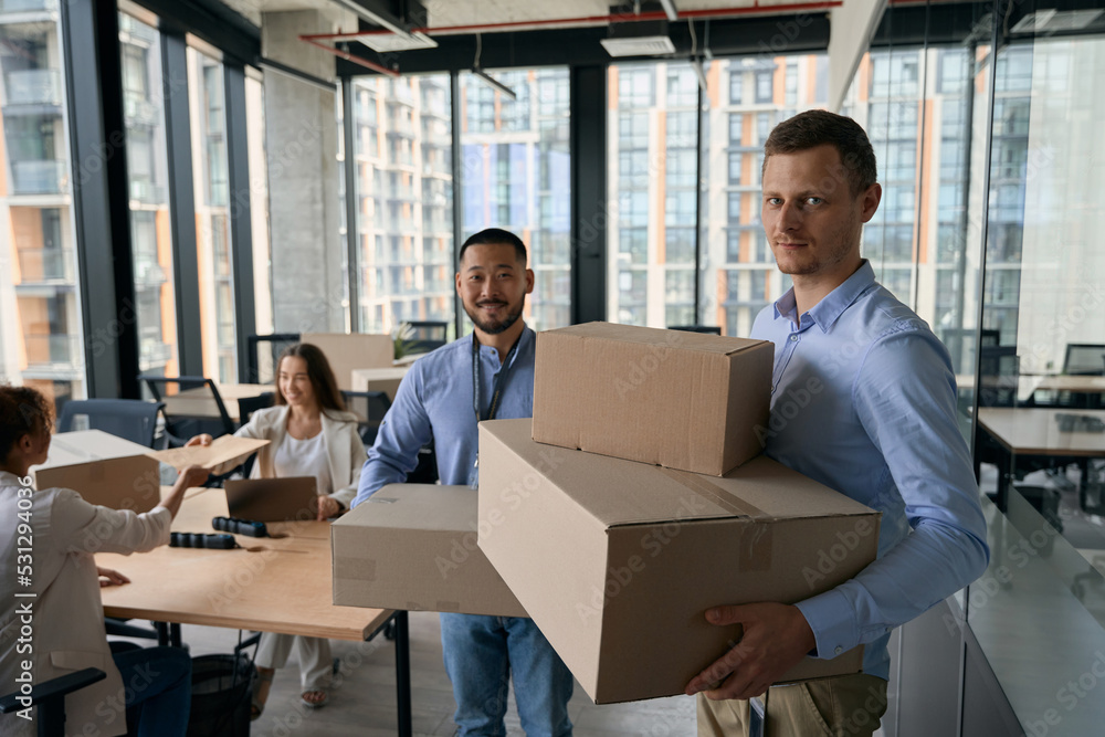 Team of company employees involved in office move Team of company employees involved in office move