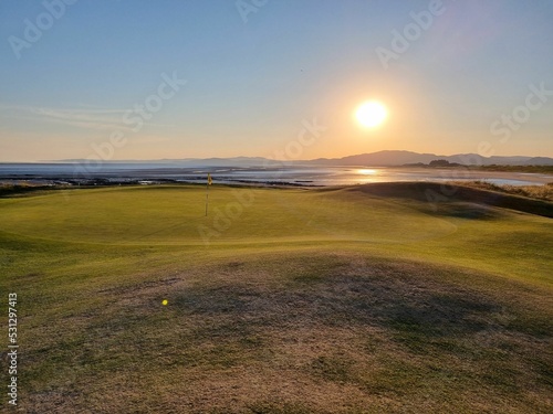 Fantastic view of sunset on a golf course in Fortrose, Highland, Scotland photo