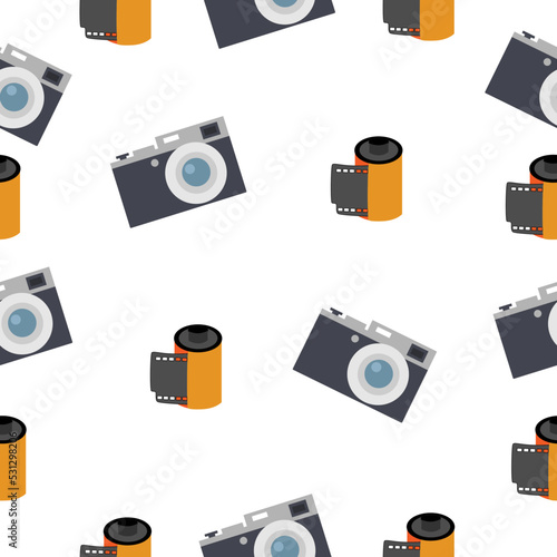 Photographic film in a reel and a camera on a white background.