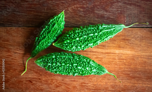Wild bitter gourd on a wooden background.