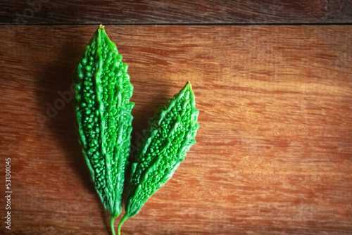 Wild bitter gourd on a wooden background.