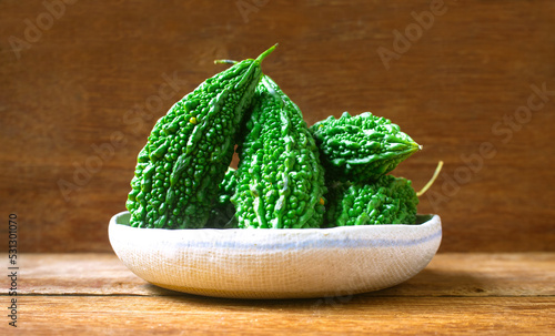 Wild bitter gourd on a wooden background.