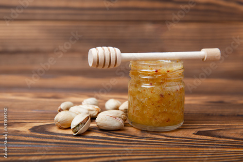 Jar of honey. Pistachio honey.Useful fortified beekeeping product for health and beauty.Cream honey.Vegetarian diet organic product.Copy space. place for text