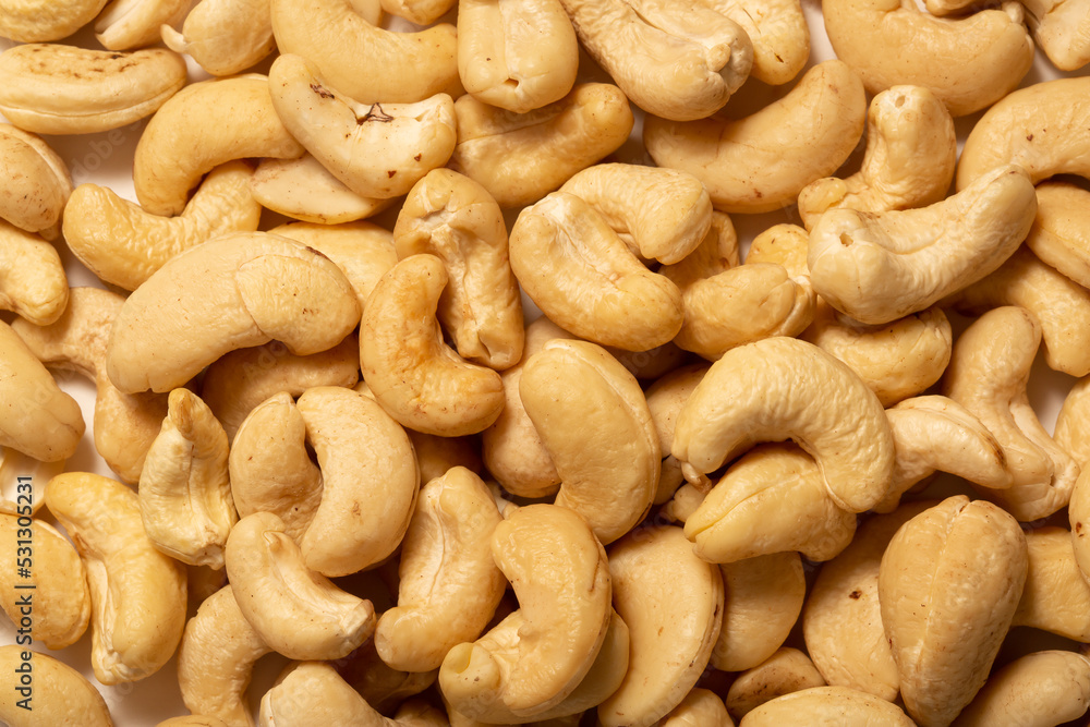 Cashew nuts as a background, top view. Cashew isolated on white background. Healthy foods. Cashew nuts as a background, top view. Cashew isolated on white background. Healthy foods.