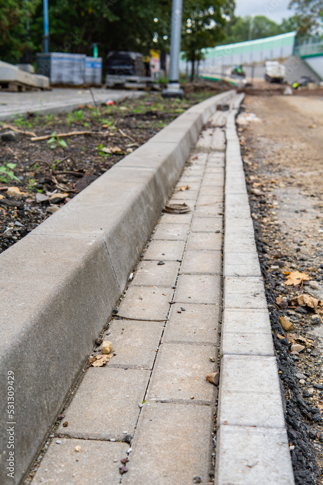 A finished gutter next to an unfinished road A finished gutter next to an unfinished road