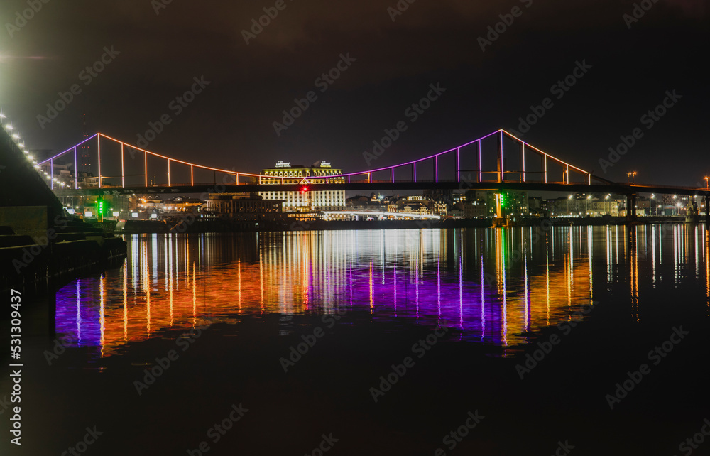 KIEV, UKRAINE - JANUARY 6, 2020: PARK BRIDGE (pedestrian bridge) ILLUMINATED BY NIGHT