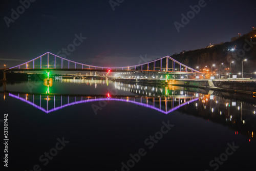 KIEV, UKRAINE - JANUARY 6, 2020: PARK BRIDGE (pedestrian bridge) ILLUMINATED BY NIGHT