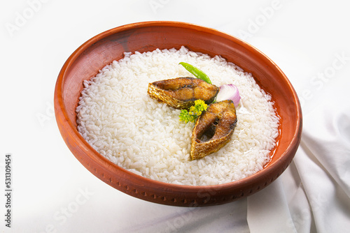 ilish panta Bengali new year festive dish. Boishakh panta ilish with green chilli and onion. Panta bhat is popular among Bengali's in India and Bangladesh. into clay plate seving bowl shanki or sanki photo