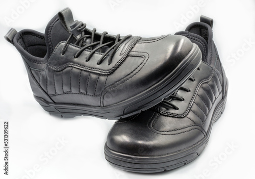 Pair of black man leather shoes with shoelace on white.