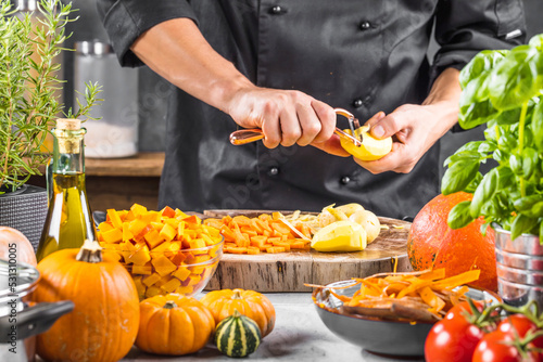 mid section of chef preparing fresh organic ingredients for pumpkin soup
