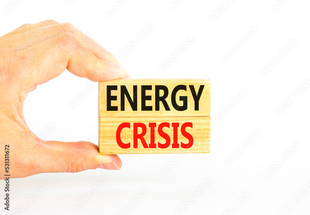Global energy crisis symbol. Concept words Energy crisis on wooden blocks. Beautiful white table white background. Businessman hand. Business global energy crisis concept. Copy space. Global energy crisis symbol. Concept words Energy crisis on wooden blocks. Beautiful white table white background. Businessman hand. Business global energy crisis concept. Copy space.