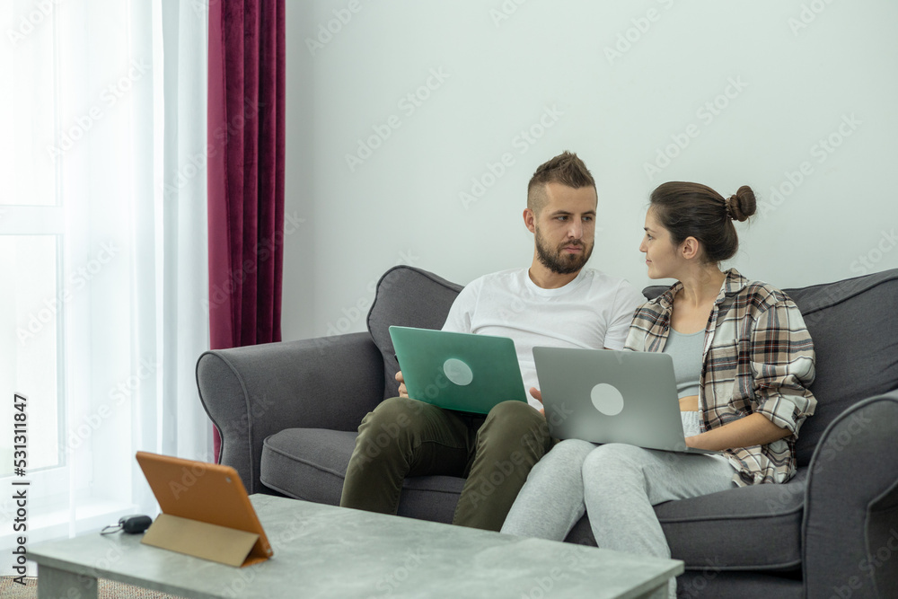 Couple at home doing online shopping with laptop Couple at home doing online shopping with laptop