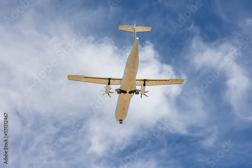 Bottom view of an propeller airplane ready to land with wheels off