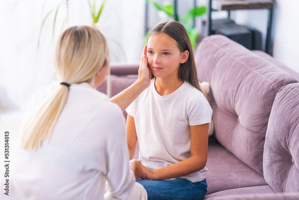 mom or psychologist, talks to child holding hands, supporting at home, expressing emotions. an anxious teenage girl listens to psychologist at meeting talking about her problems. Successful therapy mom or psychologist, talks to child holding hands, supporting at home, expressing emotions. an anxious teenage girl listens to psychologist at meeting talking about her problems. Successful therapy