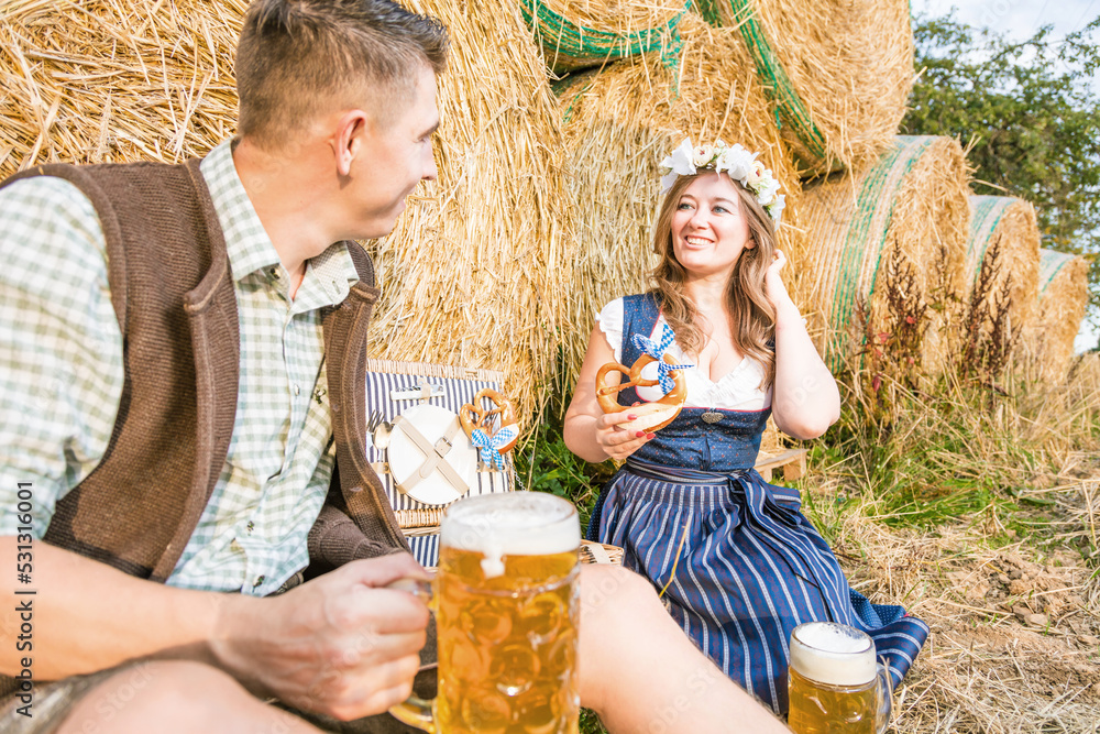 Φωτογραφία Young woman and man with beer glass and pretzel on wooden background