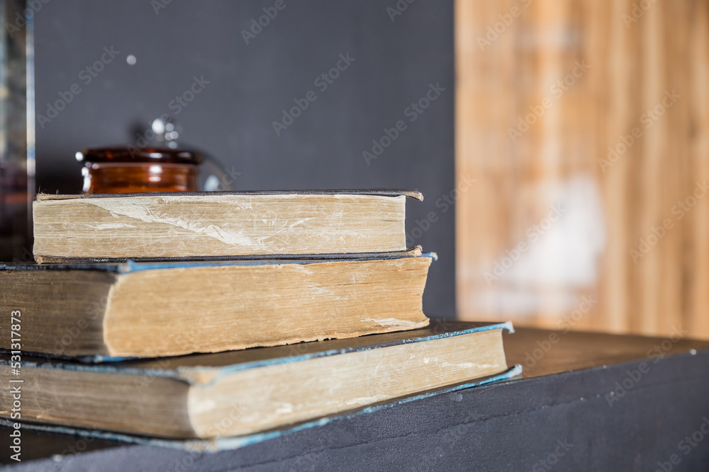 Heap of books with blurred background. Old Books on wooden shelves in the library.Reading and writing concept Heap of books with blurred background. Old Books on wooden shelves in the library.Reading and writing concept