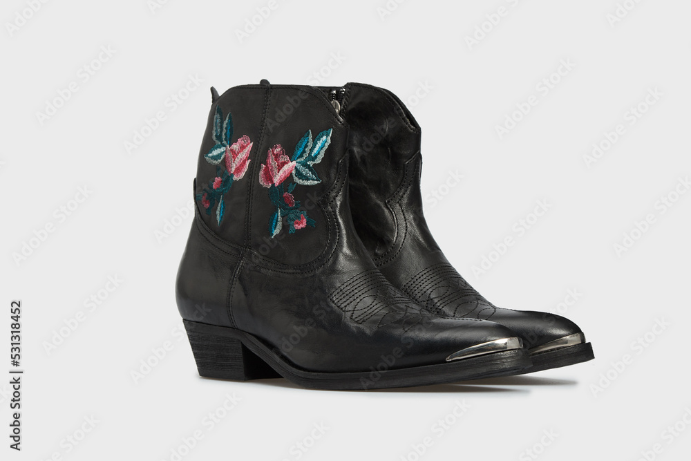 Black women's fashion cossack Chelsea Cowboy boot isolated on white background. Female classic spring autumn shoe with Pointy Toe, heel. Casual footwear with embroidery flowers stitch. Template Black women's fashion cossack Chelsea Cowboy boot isolated on white background. Female classic spring autumn shoe with Pointy Toe, heel. Casual footwear with embroidery flowers stitch. Template