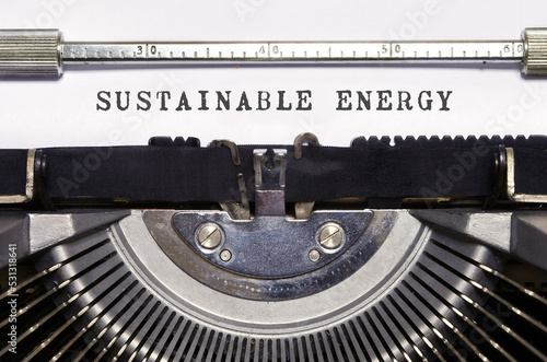 Text "sustainable energy" written with a typewriter