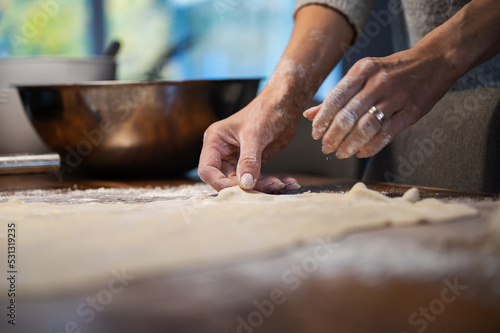 Low angle view of a woman preparing homemade pastry dough for a strudel or pie