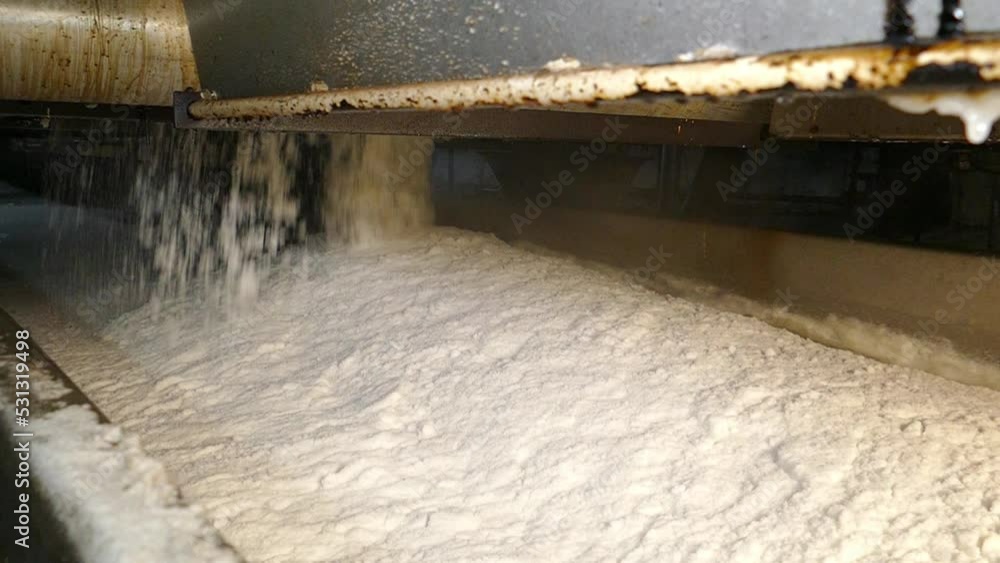 Sugar production in the food processing plant, slow motion. Crystallization of sugar from sugar syrup obtained by extraction from sugar beet in a factory Sugar production in the food processing plant, slow motion. Crystallization of sugar from sugar syrup obtained by extraction from sugar beet in a factory