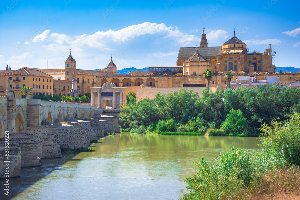 Cordoba, Spain. Roman Bridge on Guadalquivir river and The Great Mosque (Mezquita Cathedral) in the city of Cordoba, Andalusia.
