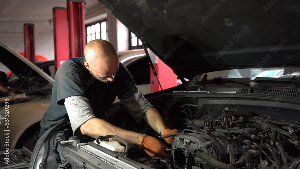 Auto mechanic repairs car engine. car service. close-up. Auto mechanic repairs car engine. car service. close-up.
