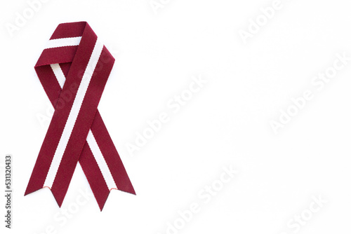 Ribbon in the colours of Latvian flag isolated on a white background.
