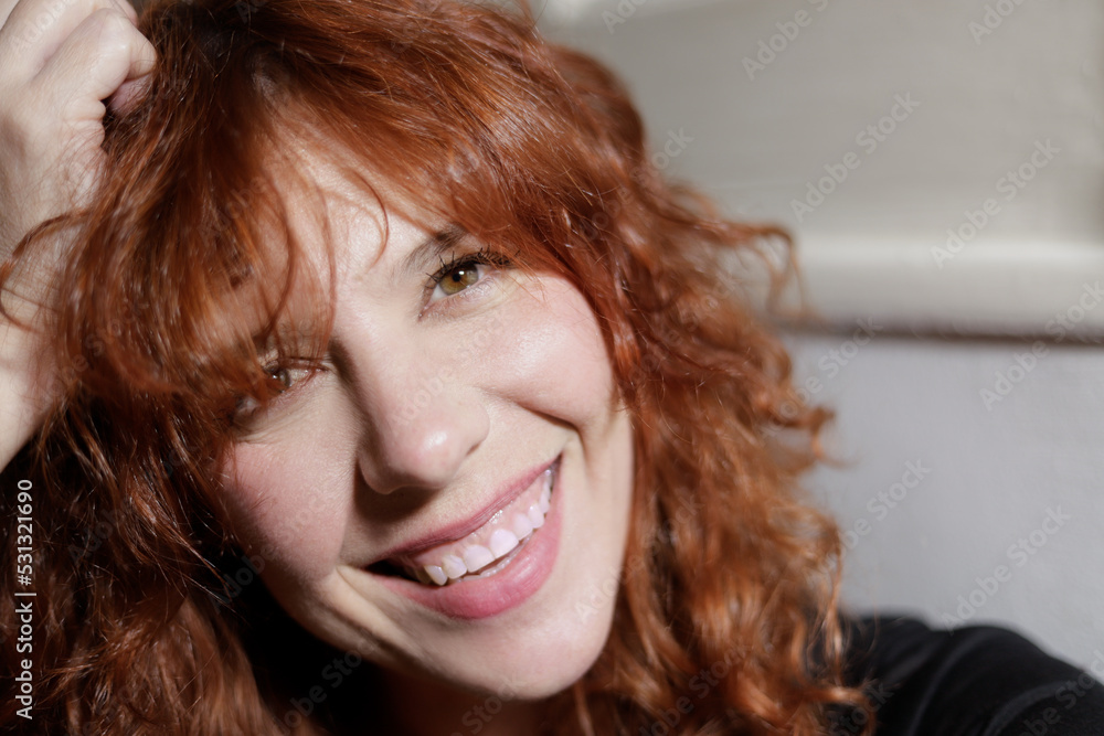 portrait of red haired woman looking at camera with big smile portrait of red haired woman looking at camera with big smile