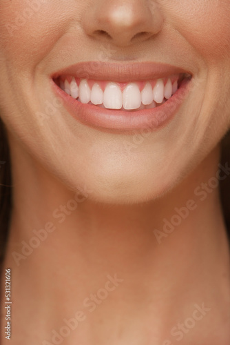 detail of a woman s smile with perfect white teeth and lips with lipstick