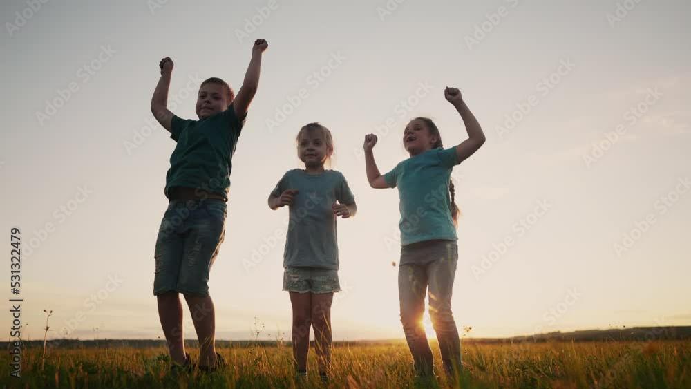 happy kid child a jump. group team of children jump silhouette in the park at sunset rejoice in victory. happy family kid dream concept. freedom happiness childhood concept. lifestyle children jump happy kid child a jump. group team of children jump silhouette in the park at sunset rejoice in victory. happy family kid dream concept. freedom happiness childhood concept. lifestyle children jump