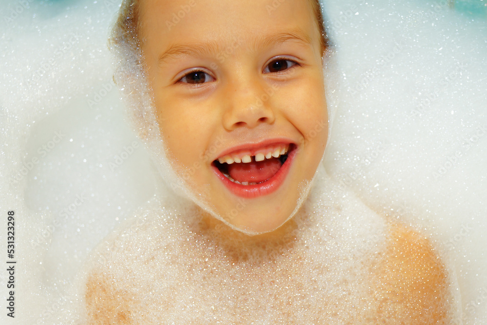 Little sweet girl takes bath with bath foam. Funny expression. Joy on face, smile. Little sweet girl takes bath with bath foam. Funny expression. Joy on face, smile.