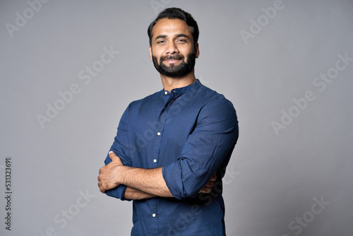 Billede på lærred Proud confident bearded indian business man investor, rich ethnic ceo, corporate executive, professional lawyer banker, male office employee standing isolated on gray with arms crossed