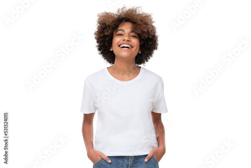 Front view of laughing african teen girl standing with hands in pockets, wearing white tshirt with copy space photo