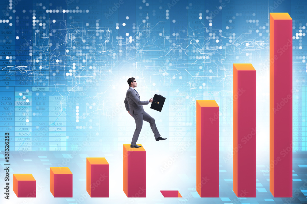 Businessman in growth concept with bar charts Businessman in growth concept with bar charts