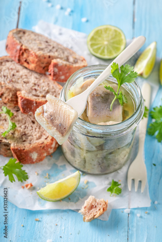 Fresh marinated herring in oil, onions and herbs.
