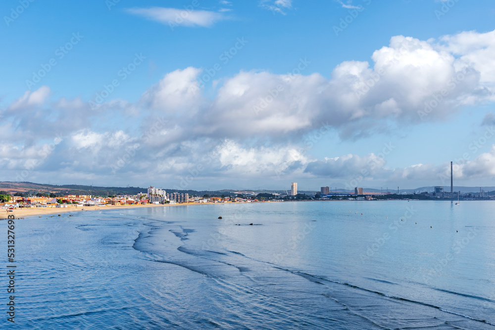 View of the Rinconcillo beach in Algeciras, with the industrial zone of Los Barrios in the background.