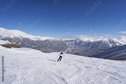 Woman skier on the ski slope in the mountains