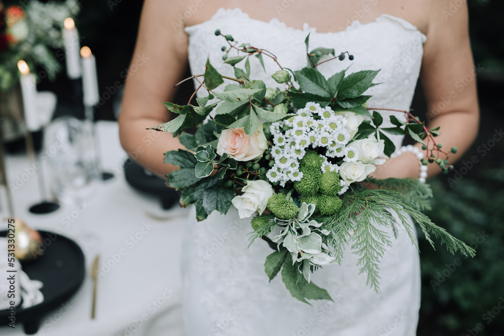 Young beautiful bride holding bouquet in boho style Young beautiful bride holding bouquet in boho style