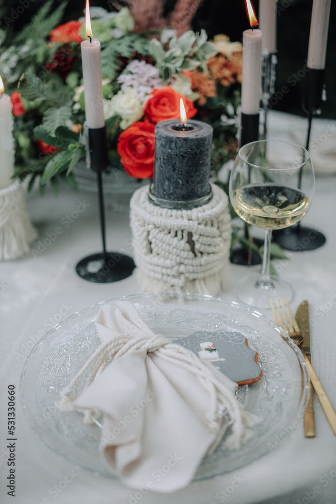 Modern wedding table decorated with plates, cutlery and flowers Modern wedding table decorated with plates, cutlery and flowers