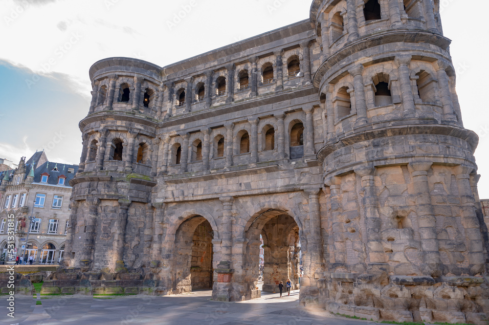 Trier October 2021: The Porta-Nigra, Latin for Black Gate, is an earlier Roman city gate built from 170 AD on Porta-Nigra-Platz and a symbol of the city of Trier.
