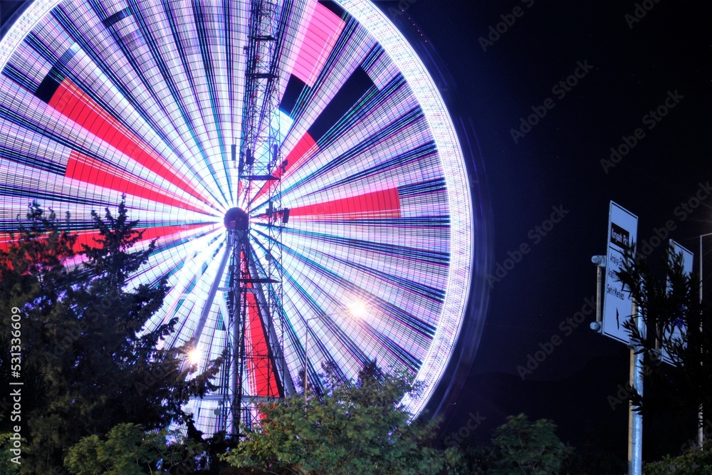 Ferris wheel in Antalya night with blurred lights lines