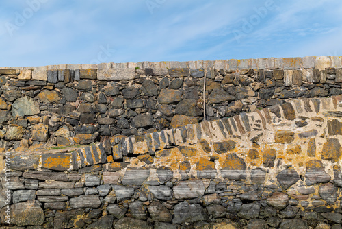 9 September 2022. Portsoy, Aberdeenshire,Scotland. This is the old harbour pier at Portsoy with the lines of boats having been moored. photo